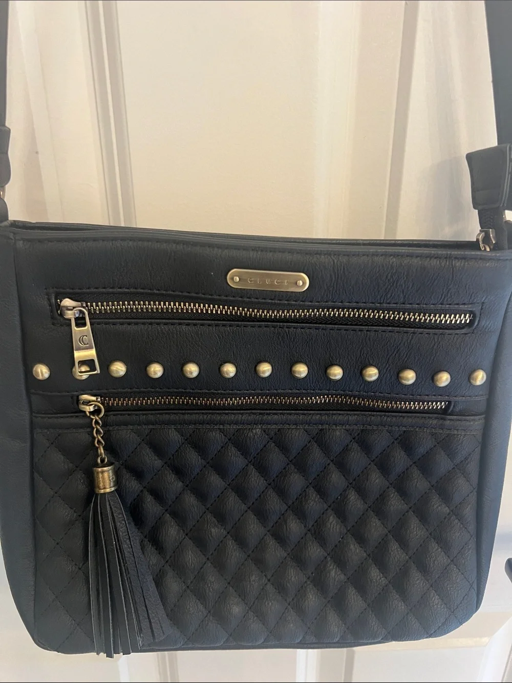 Black Quilted Crossbody Bag with Tassel and Stud Details